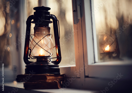 Vintage kerosene lamp and old books