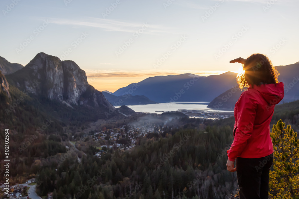 Adventurous Girl Hiking in the mountains during a sunny Autumn Sunset. Taken Squamish, North of Vancouver, British Columbia, Canada. Concept: Adventure, freedom, lifestyle Adventurous Girl Hiking in the mountains during a sunny Autumn Sunset. Taken Squamish, North of Vancouver, British Columbia, Canada. Concept: Adventure, freedom, lifestyle
