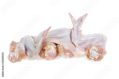 Raw chicken on cutting board on white background