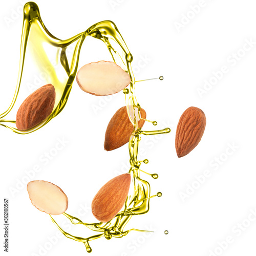 Tableau sur toile Splash of almond oil and nuts on white background