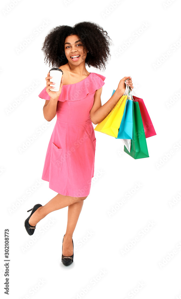 Beautiful African-American woman with shopping bags and coffee on white background Beautiful African-American woman with shopping bags and coffee on white background