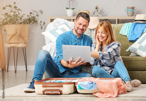 Couple with laptop and lugg...
