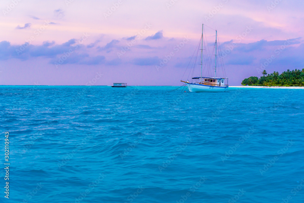 Yacht near the pier of a fabulous island in the Maldives.