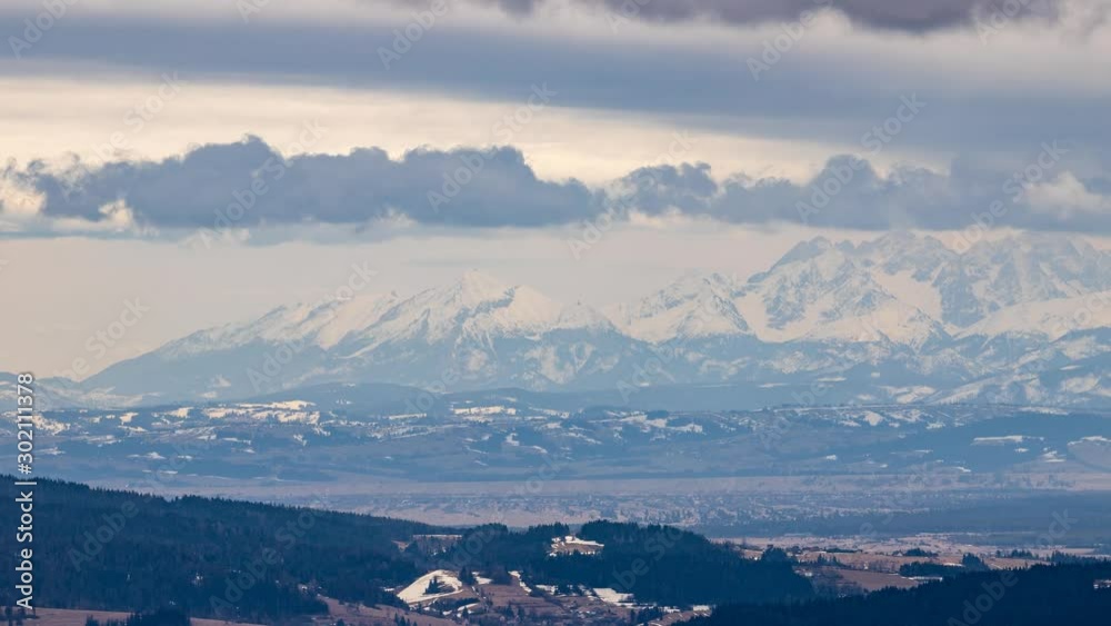 Clouds flying over Tatra mountains during late winter afternoon. Video with camera motion. Clouds flying over Tatra mountains during late winter afternoon. Video with camera motion.