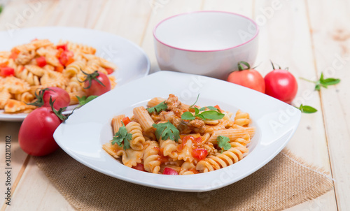 Spaghetti pasta with and tomato sauce on wood background