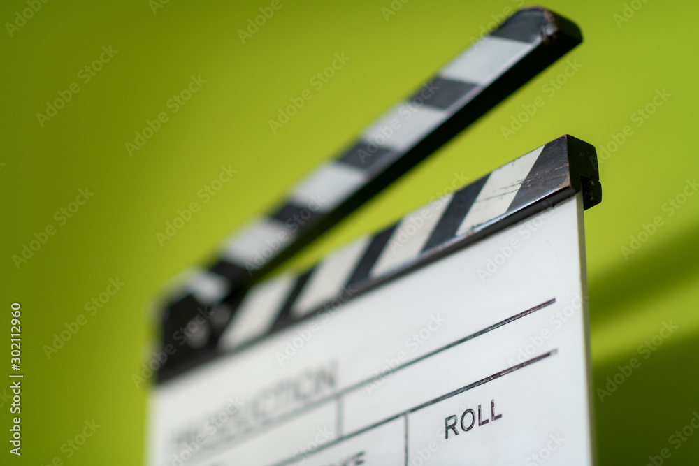 Naklejka premium movie clapper on green background