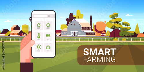 farmer hand holding smartphone monitoring condition controlling agricultural products organization of harvesting smart farming concept farm building landscape background horizontal copy space vector