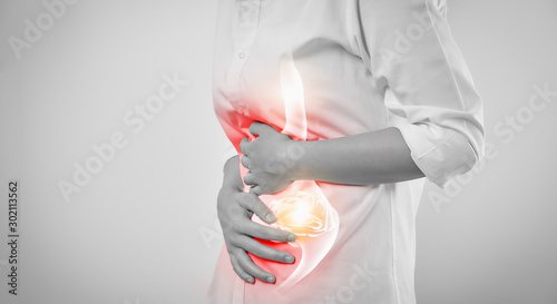 Woman hands touching belly and stomach painful suffering from chronic gastritis on white background. Healthcare concept.