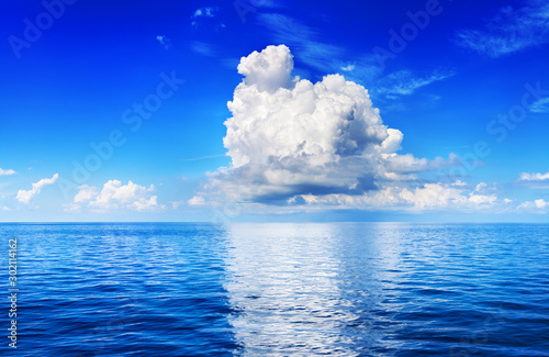 Fototapeta Naklejka Na Ścianę i Meble -  White cumulus clouds in blue sky over sea landscape, big cloud reflection on water above ocean panorama, scenic tropical seascape panoramic view sunny summer day cloudy weather, cloudscape, copy space