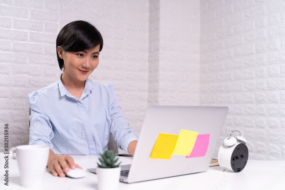 Happy woman sitting at home office working using computer laptop Happy woman sitting at home office working using computer laptop