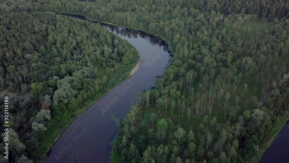 The curve of river Gauja between woods - AERIAL TILT UP shot The curve of river Gauja between woods - AERIAL TILT UP shot