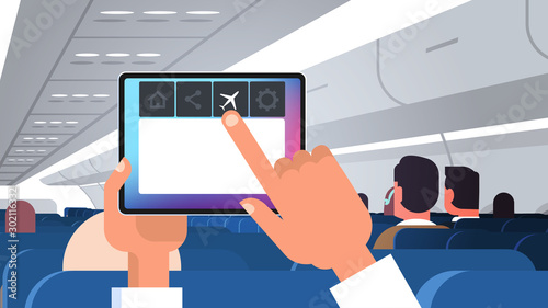 human hand holding tablet pc with flight mode rules of airplane safety concept modern plane board with passengers horizontal flat vector illustration