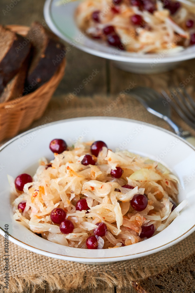 Sauerkraut with cranberries in a white bowl Sauerkraut with cranberries in a white bowl