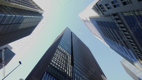 大手町ビジネス街の風景 歩き撮り / A dolly shot of a business district lined with skyscrapers. Cityscape of flowing buildings and signals. Chiyoda, Tokyo, Japan.