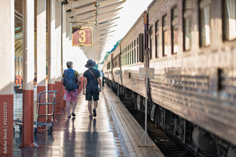 custom made wallpaper toronto digitalTraveler on platform with backpack and belongings in the railway train station.