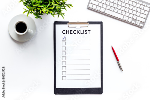 Checklist on white office background top view photo