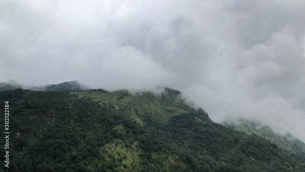 Day timelapse of clouds movement over the top of a hill on a cloudy day. Wide shot and was taken on the way to Poon Hill, Kaski, Nepal while trekking. Day timelapse of clouds movement over the top of a hill on a cloudy day. Wide shot and was taken on the way to Poon Hill, Kaski, Nepal while trekking.