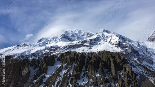 Day timelapse of Annapurna Mountain Range with clouds in a Sunny day from Manang, Nepal.Wide shot. photo