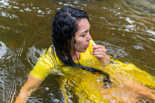 beautiful woman with yellow dress inside the water