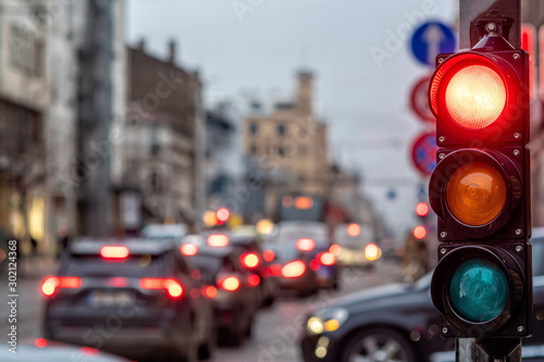 A city crossing with a semaphore. Red light in semaphore