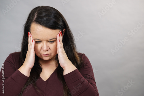 Worried woman having painfull headache