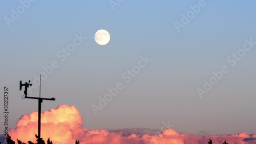 weather station during sunset with the moon in the background photo