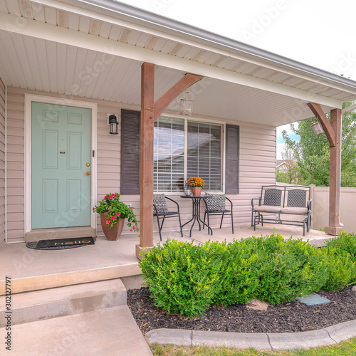 Square frame Front porch of modern home with landscaped garden