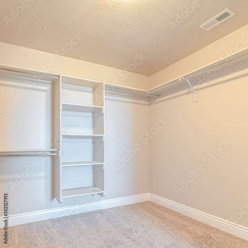 Square frame Interior of walk in closet with bare shelving