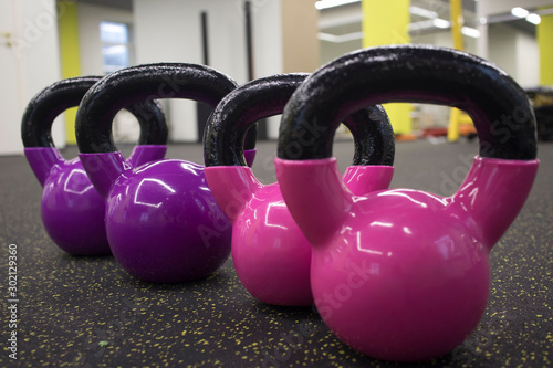 Fototapeta Naklejka Na Ścianę i Meble -  multi-colored kettlebells in the gym, the concept of sports and physical activity