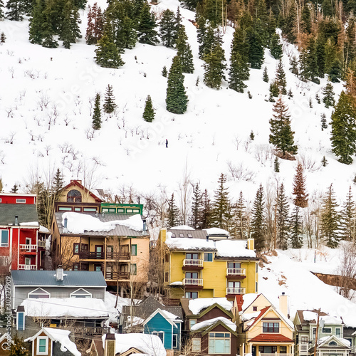 Square frame Houses and cabins on a mountain blanketed with snow in Park City Utah in winter