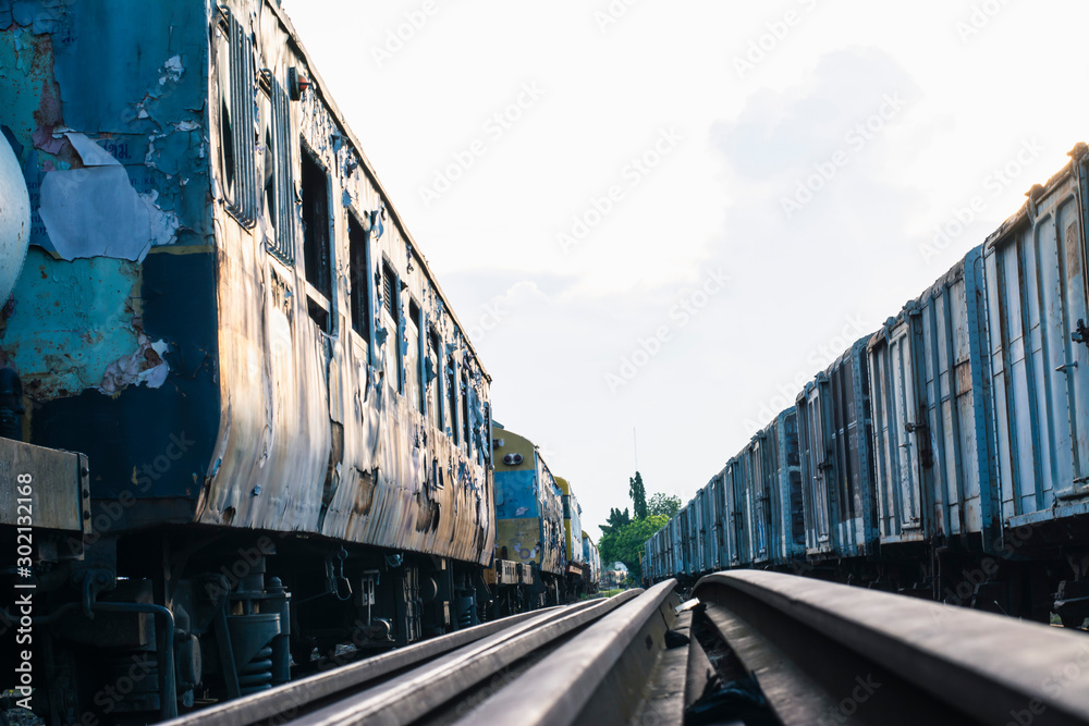 Fototapeta premium Abandoned trains and an old iron trestle bridge