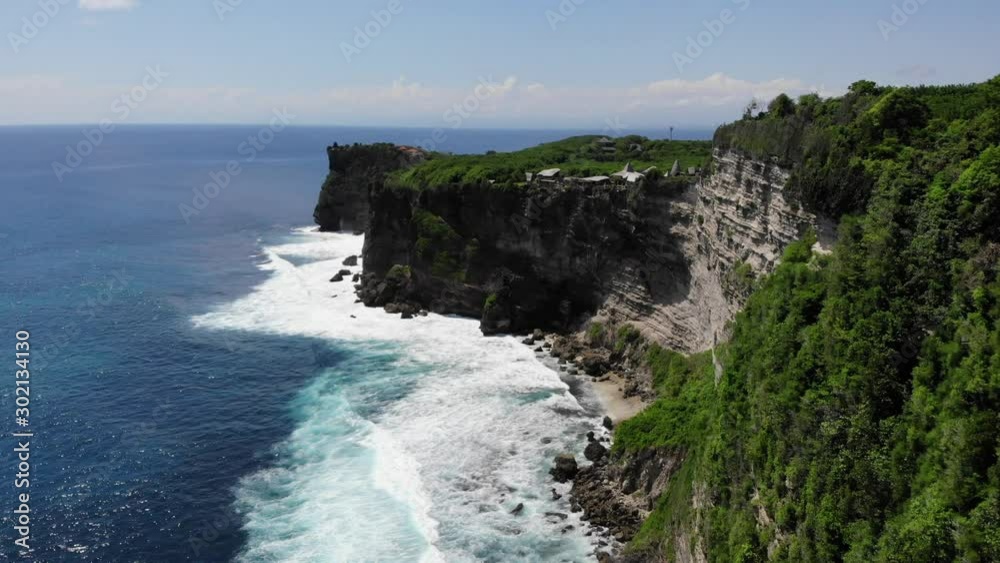 Aerial: flying trough the ocean, waves breaking on the cliff, Uluwatu, Bali Aerial: flying trough the ocean, waves breaking on the cliff, Uluwatu, Bali