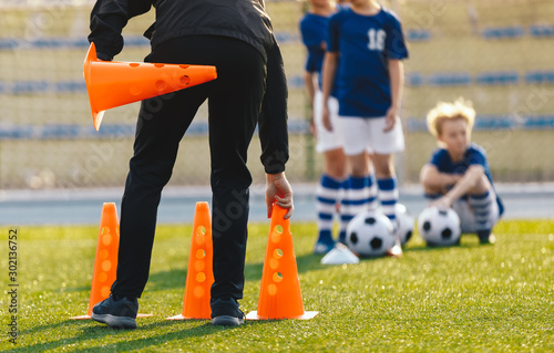Soccer Coach Placing Training Cones for Kids Sports Team. Children on Soccer ...