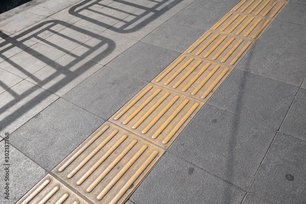 Fototapeta premium Tactile paving on footpath for blind pedestrians