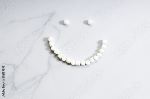Smile-shaped marshmallows stopmotion on white background