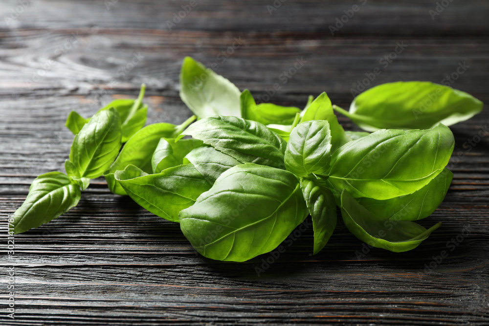 Fresh green basil on black wooden table, closeup Fresh green basil on black wooden table, closeup