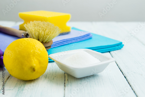 dishwashing tools and citric acid, lemon on white wooden