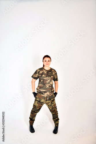 girl with red hair in a military uniform and black gloves poses in various poses