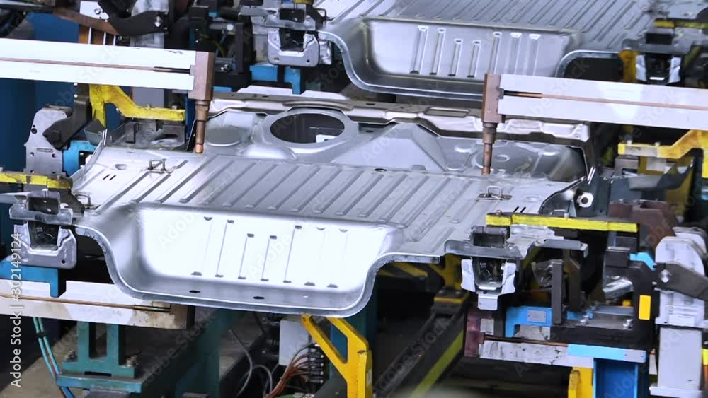 Automobile manufacturing industry. Robots soldering car parts on the production line