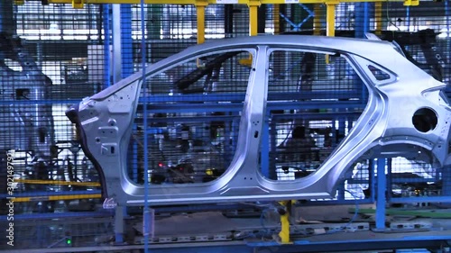 Automobile manufacturing industry. Robots soldering car parts on the production line