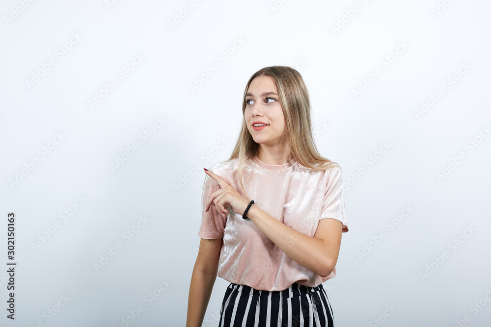 Attractive young unshaven woman in casual shirt showing on workspace isolated on white wall background studio portrait. People sincere emotions lifestyle concept. Attractive young unshaven woman in casual shirt showing on workspace isolated on white wall background studio portrait. People sincere emotions lifestyle concept.