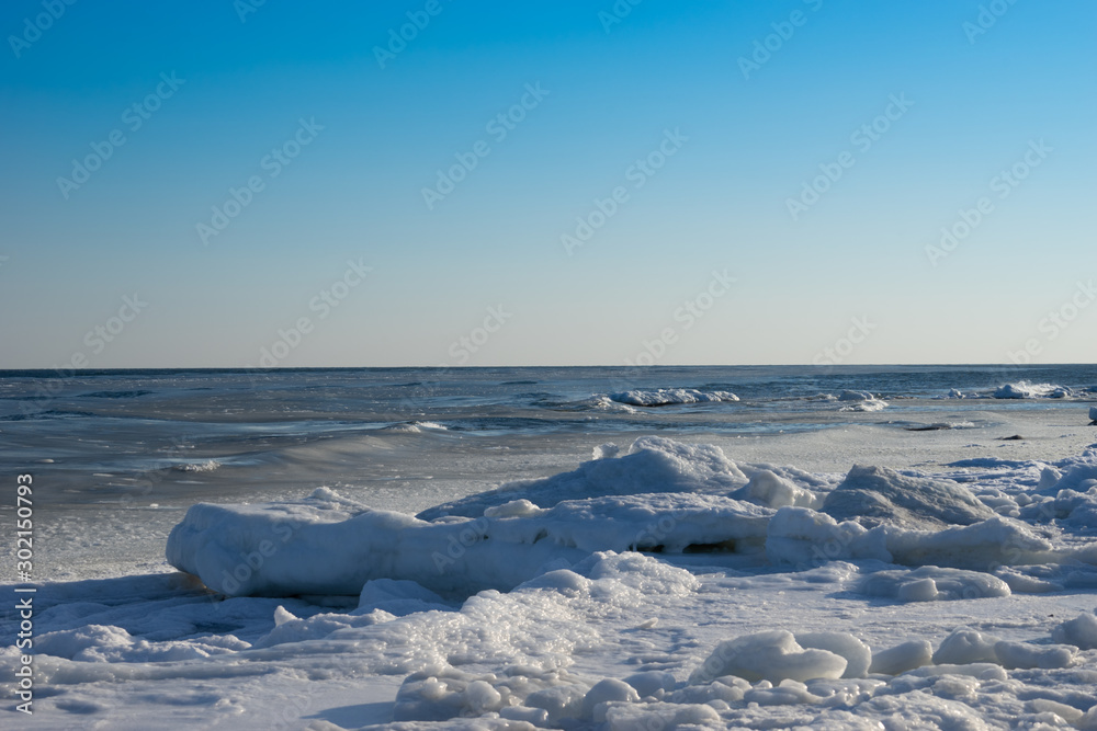 Seascape with coastline in ice and snow