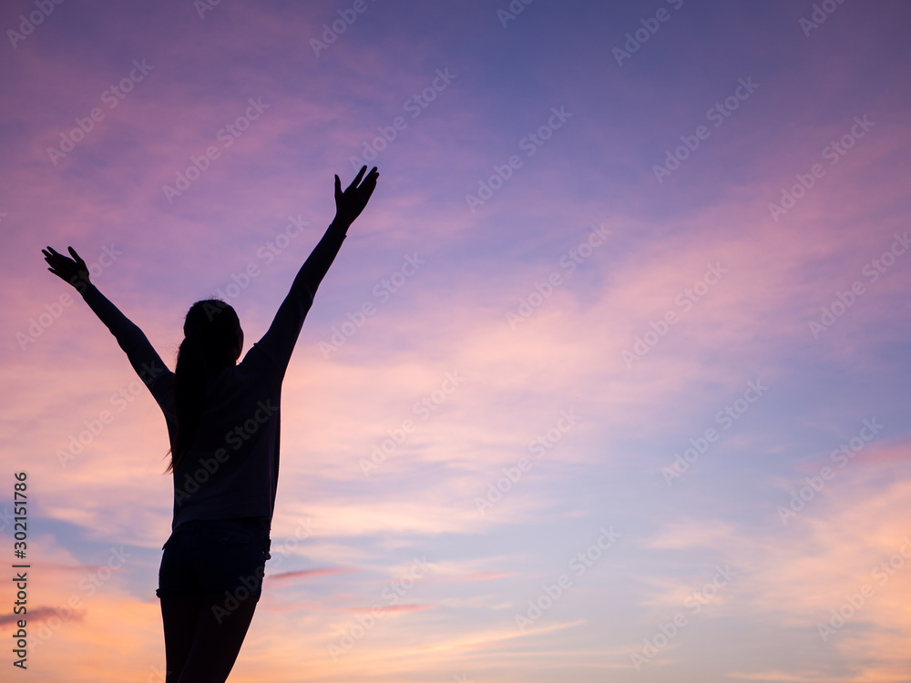 Happiness woman stay outdoor under sunlight of sunset