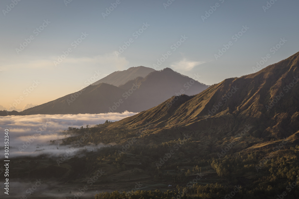 Sunrise with morning low clouds at Mount Batur in Bali