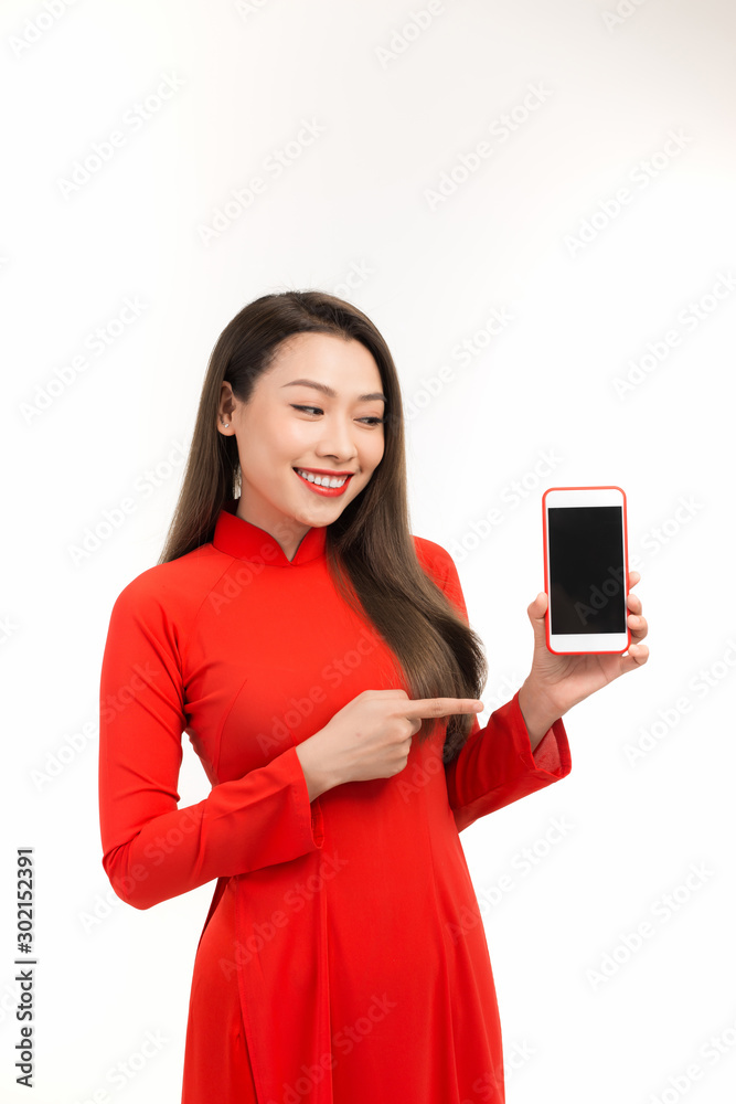 Portrait of a joyful asian woman showing blank screen mobile phone isolated over white background Portrait of a joyful asian woman showing blank screen mobile phone isolated over white background