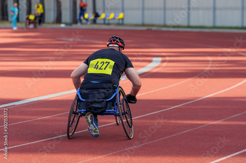 Athlete on a track of the stadion, getting ready for a wheelchair race.