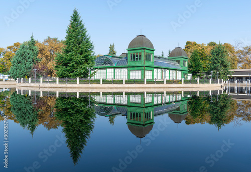 A colorful view of the small mirror lake and the reflections of autumn trees and the romantic Viennese pavilion in it. The territory of the International Fair Plovdiv, Bulgaria