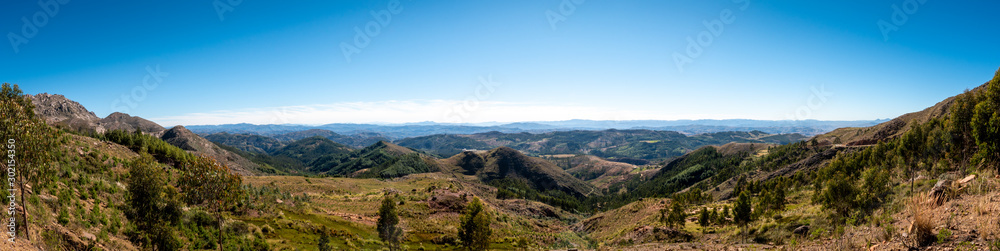 A panoramic of the inside the Maragua Crater, this landscape is beautifully coloured with a variety of minerals spread across its unique formations and spotted with dinosaur footprints and fossils.