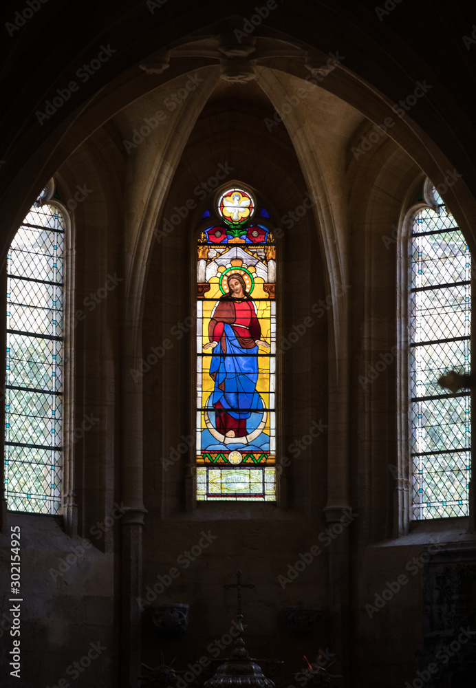 Colorful Stained Glass in medieval Sarlat Cathedral  dedicated to Saint Sacerdos. Sarlat la Caneda in Dordogne Department, Aquitaine, France