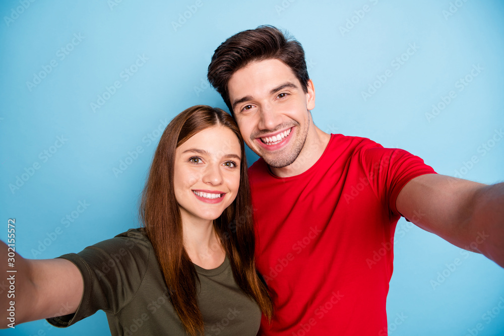Close up photo of dreamy passionate two married people students relax rest hug embrace make selfie on summer journey wear green red t-shirt isolated over pastel color background